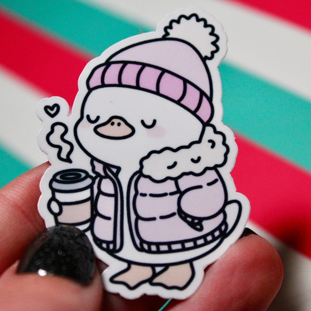 Cute Winter Duck Pink Coat Sticker – Cozy Duck in Puffer Coat – Hot Drink Duck Vinyl Sticker – Waterproof Glossy Sticker – Pastel Winter Aesthetic – 3.76cm x 5.48cm