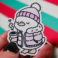 Load image into Gallery viewer, Cute Winter Duck Pink Coat Sticker – Cozy Duck in Puffer Coat – Hot Drink Duck Vinyl Sticker – Waterproof Glossy Sticker – Pastel Winter Aesthetic – 3.76cm x 5.48cm
