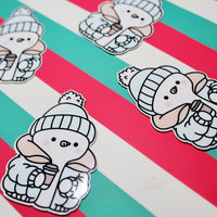 Load image into Gallery viewer, Cozy Winter Snowman Blue and Yellow Coat Sticker – Cute Snowman Vinyl Sticker – Hot Drink Snowman – Glossy Waterproof Sticker – Winter Aesthetic – 4.25cm x 6.18cm
