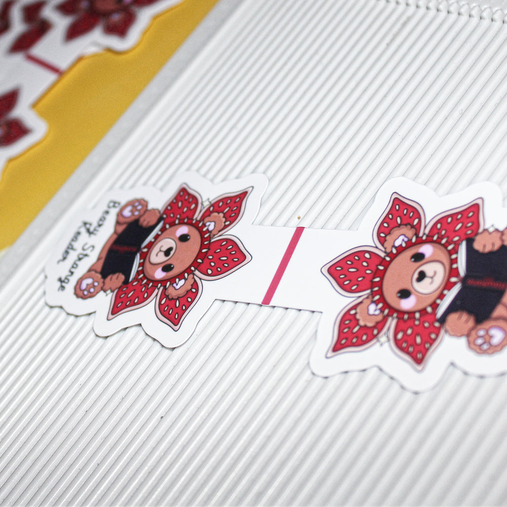 bookmarks with teddy bears and flowers on a textured surface.