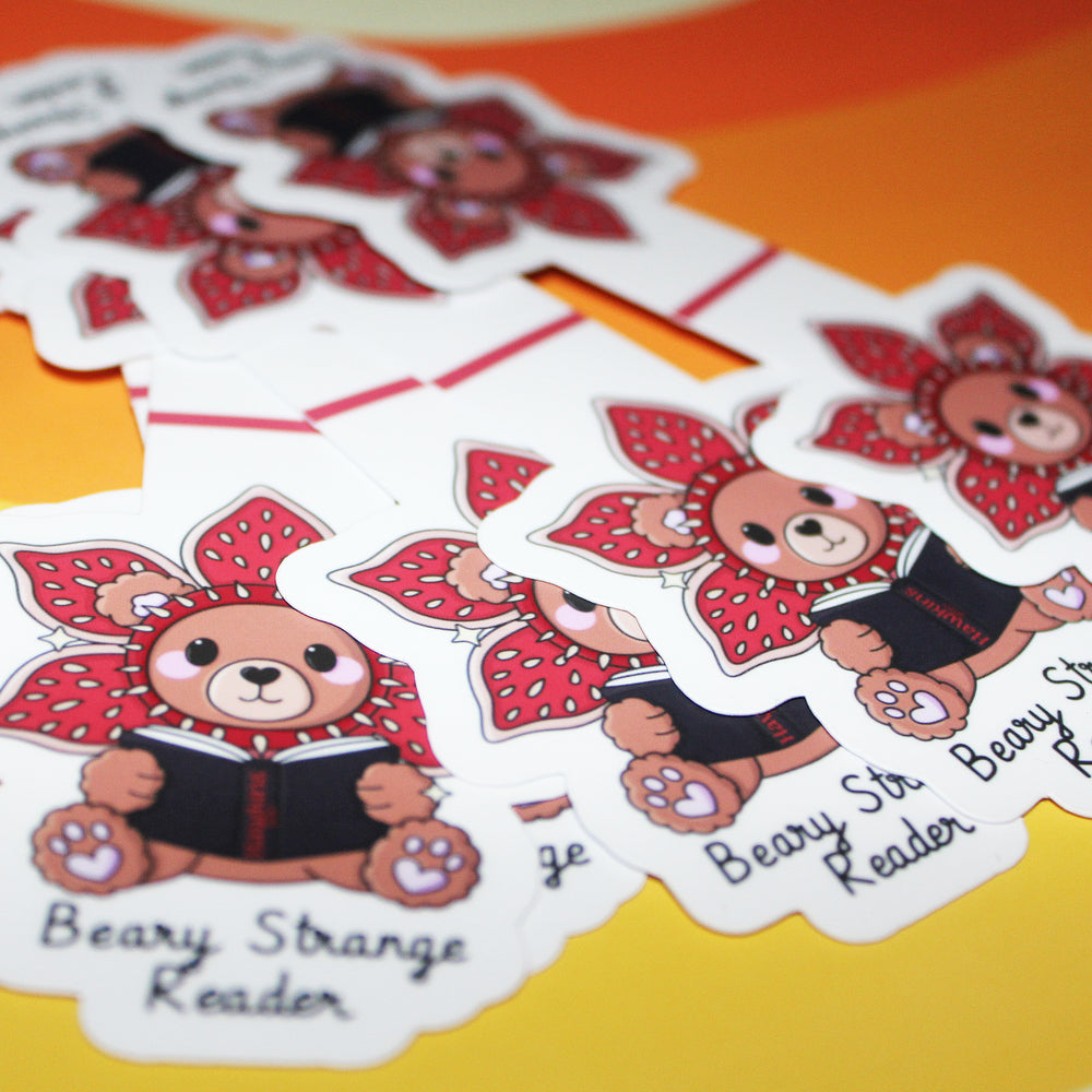 bookmarks of a bear character reading a book with text on a yellow background