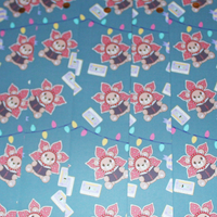 Load image into Gallery viewer, Repeating pattern of a cartoon character with flowers on a blue background
