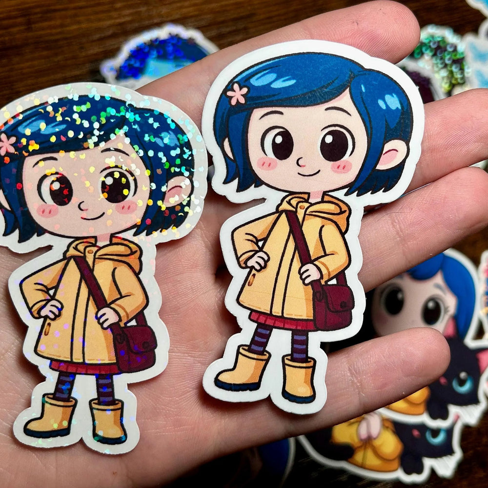 Two stickers of a character with blue hair and a yellow raincoat held in a hand.