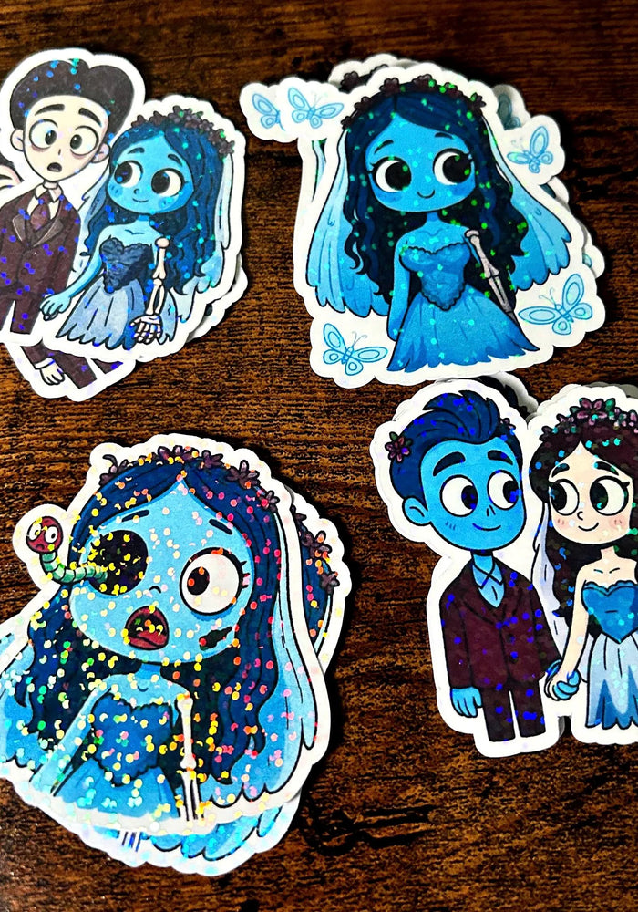 Set of four cartoon character stickers on a wooden surface