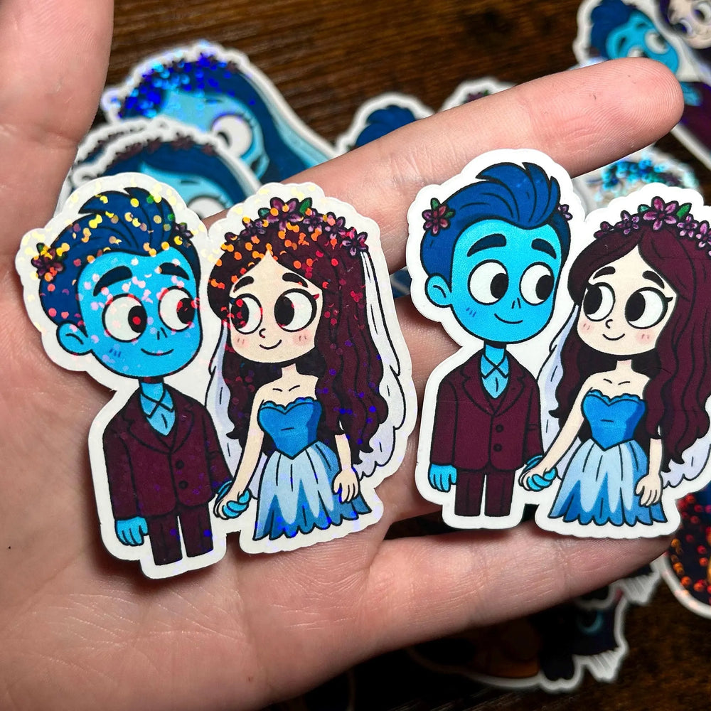 Cartoon character stickers held in a hand with a wooden surface background