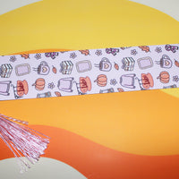 Load image into Gallery viewer, Decorative bookmark with tassel on a colourful background
