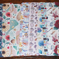 Load image into Gallery viewer, Set of colourful different flat bookmarks arranged in a row on a wooden surface.
