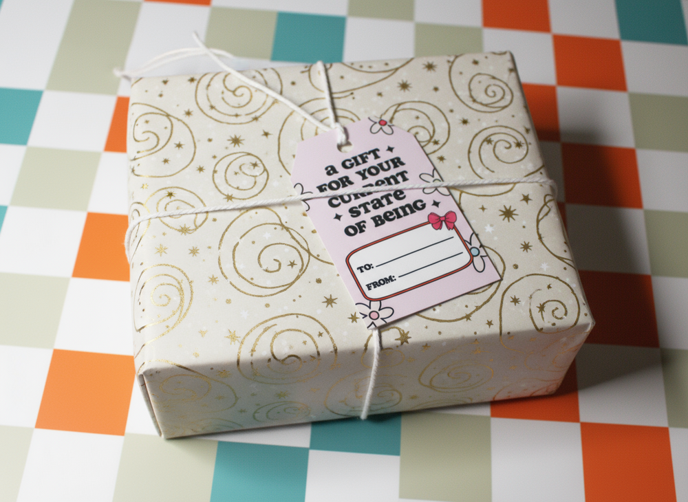 Gift box with decorative paper and a tag on a checkered tablecloth
