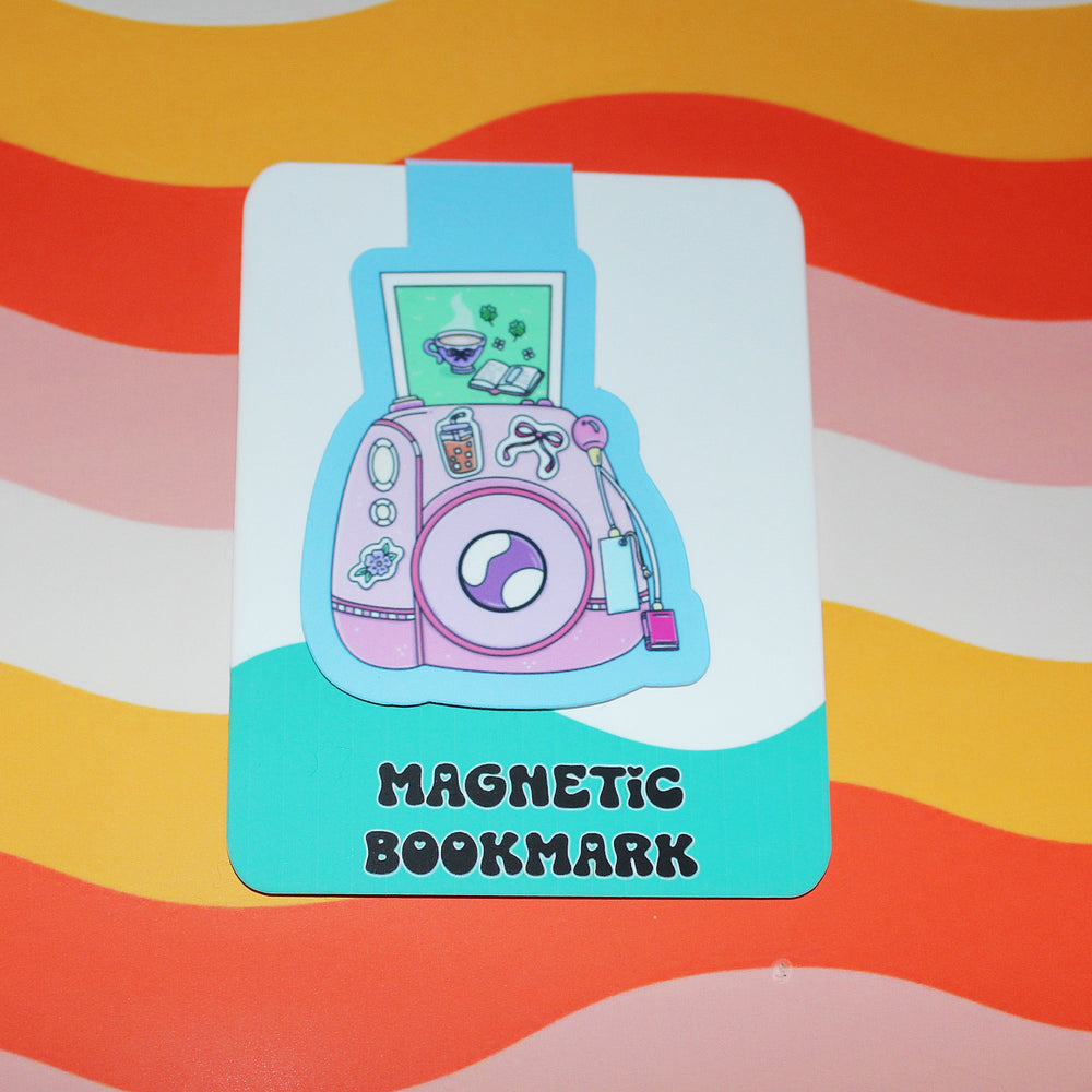Magnetic bookmark with a pink camera design on a colorful striped background
