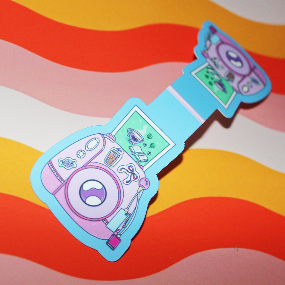 Colourful cartoon-style camera design magnetic bookmark on a wavy background