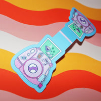 Load image into Gallery viewer, Colourful cartoon-style camera design magnetic bookmark on a wavy background
