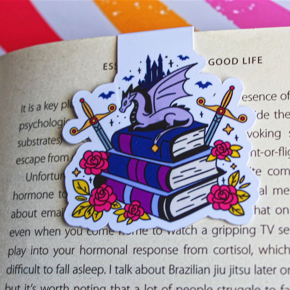 Decorative bookmark with dragon and books design on an open book
