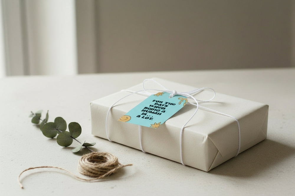 White gift box with a blue tag on a light surface