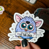 Load image into Gallery viewer, Sticker of a blue creature with text held by a hand on a wooden surface
