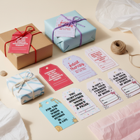 Load image into Gallery viewer, Gift boxes with colorful ribbons and humorous gift tags on a light surface.
