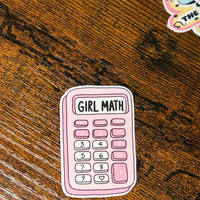 Load image into Gallery viewer, Sticker of a pink calculator with 'Girl Math' text on a wooden surface
