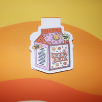 Load image into Gallery viewer, bookmark of a juice carton labeled 'Happy Juice' on an orange background
