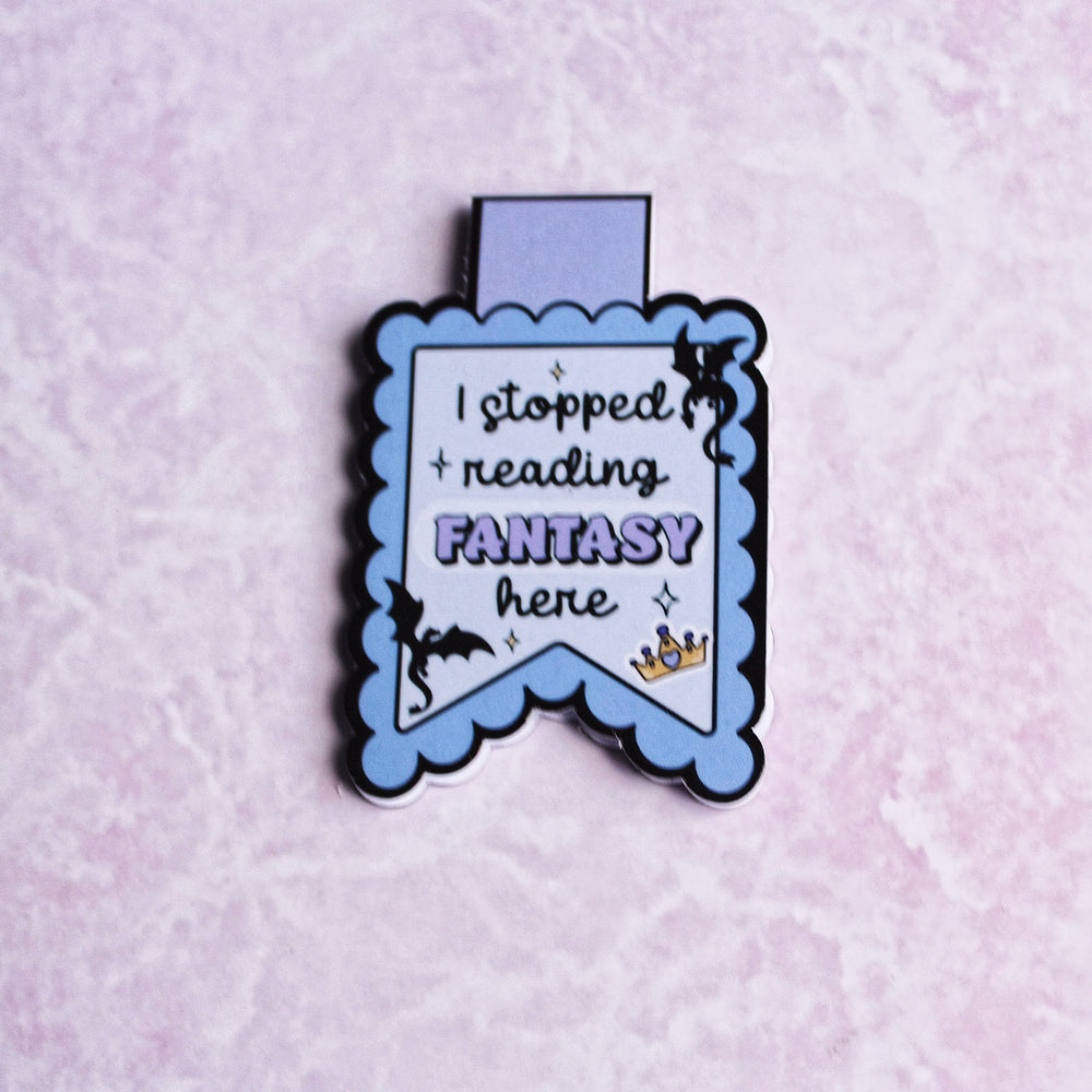 Enamel pin with text 'I stopped reading FANTASY here' on a light purple background