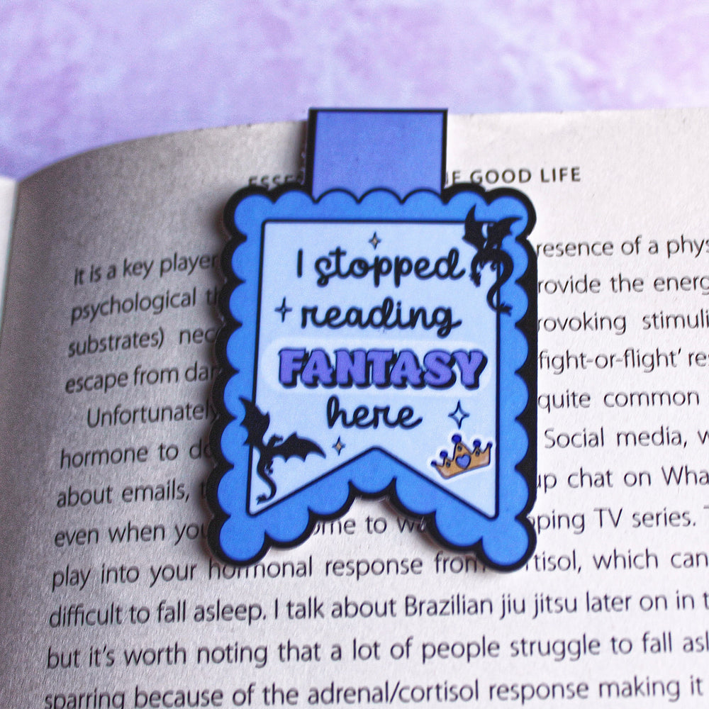Bookmark with 'I stopped reading FANTASY here' text on a book page