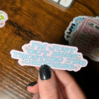 Load image into Gallery viewer, Hand holding a pink sticker with text on a wooden surface
