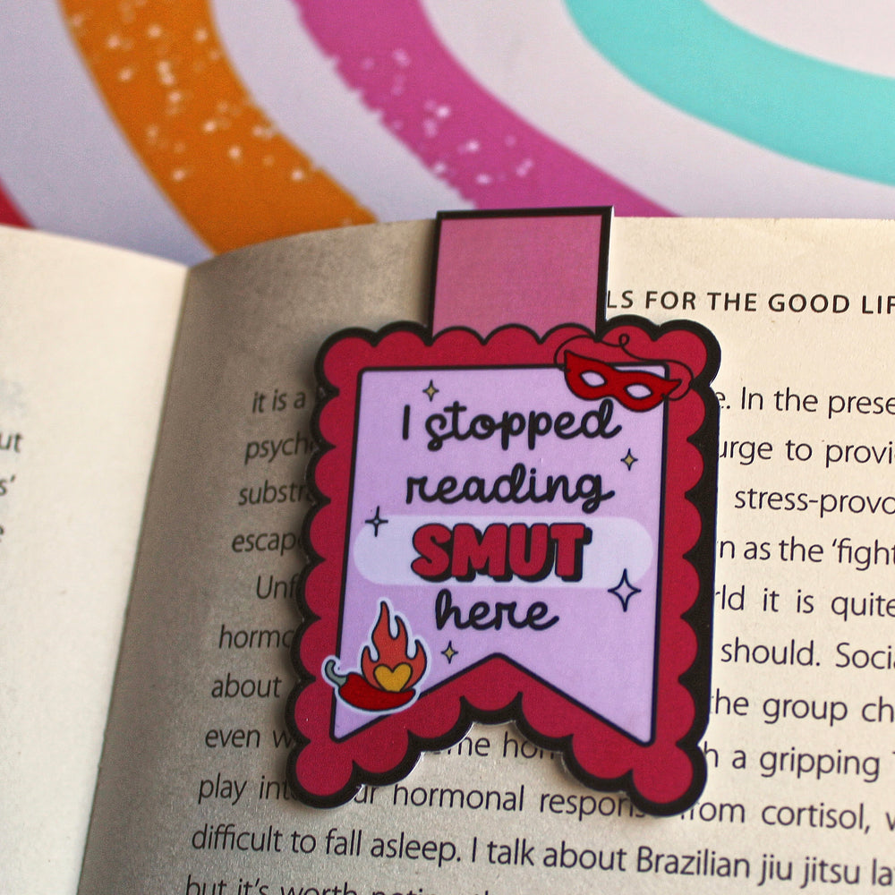 Bookmark with 'I stopped reading SMUT here' text on an open book