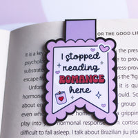 Load image into Gallery viewer, Purple bookmark with text 'I stopped reading ROMANCE here' on an open book.
