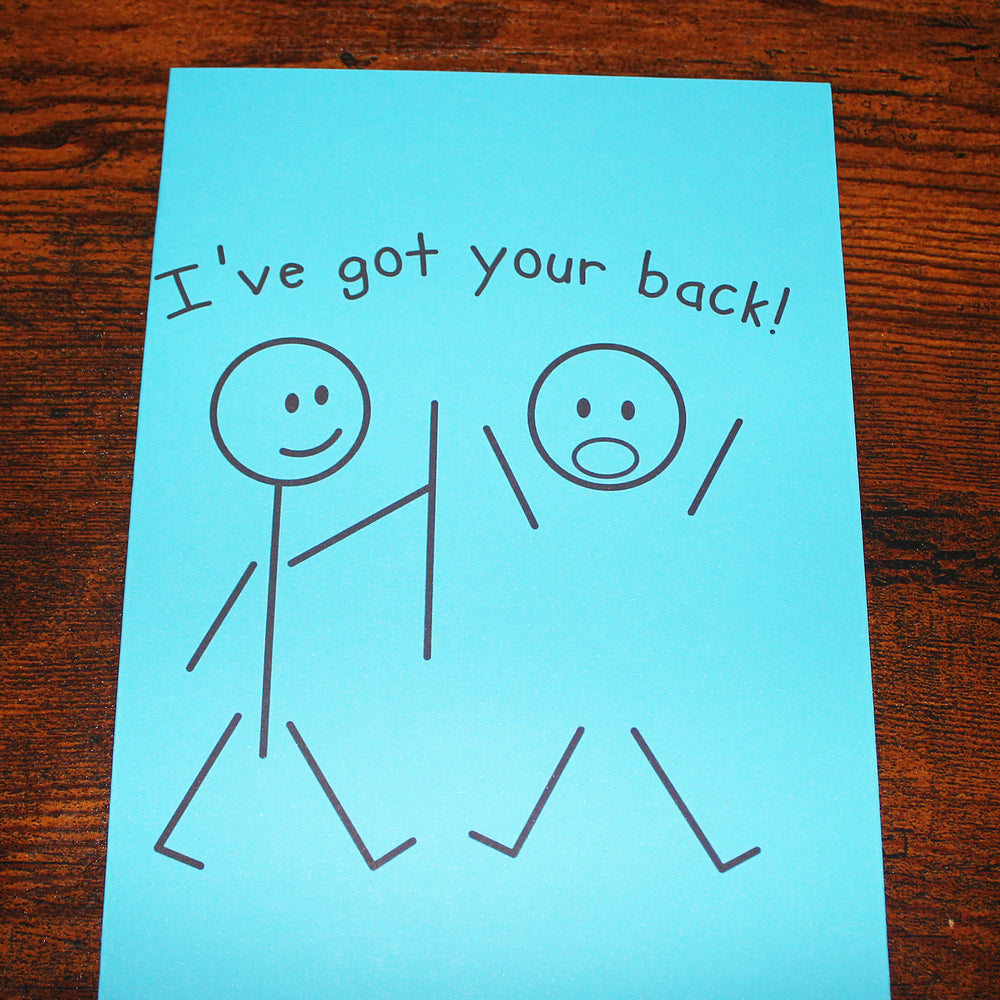 Hand-drawn illustration on blue paper with 'I've got your back!' text, on a wooden surface.
