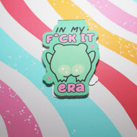 Load image into Gallery viewer, Green cartoon character with text on a colorful striped background
