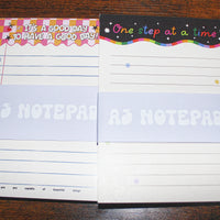 Load image into Gallery viewer, Two notepads with colorful designs and text on a wooden surface
