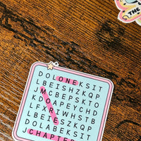 Load image into Gallery viewer, Sticker with scrambled text on a wooden surface
