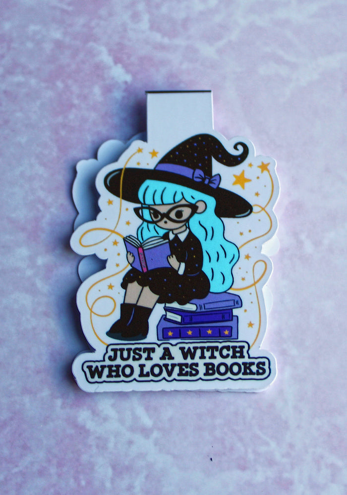 Bookmark of a cartoon witch with blue hair and a black hat on a light purple textured background.