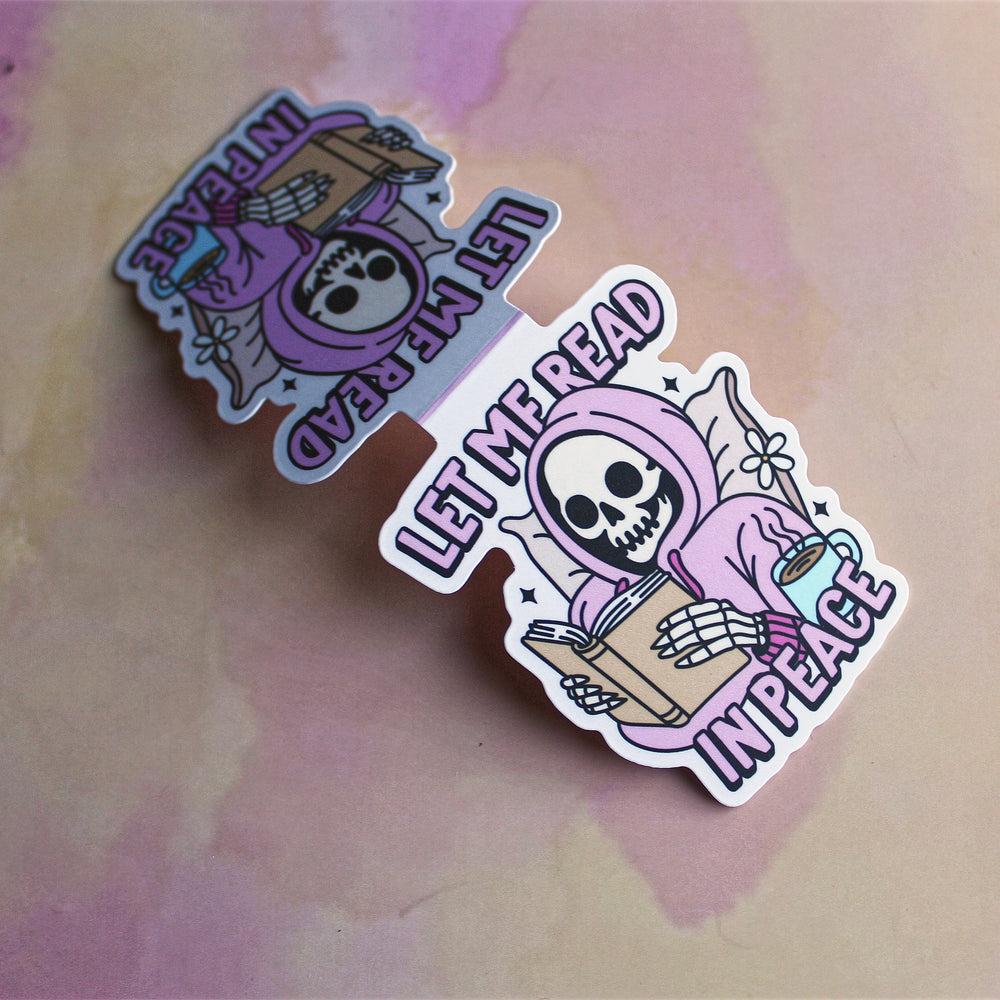 magnetic bookmark with a skeleton reading a book and text on a watercolour background