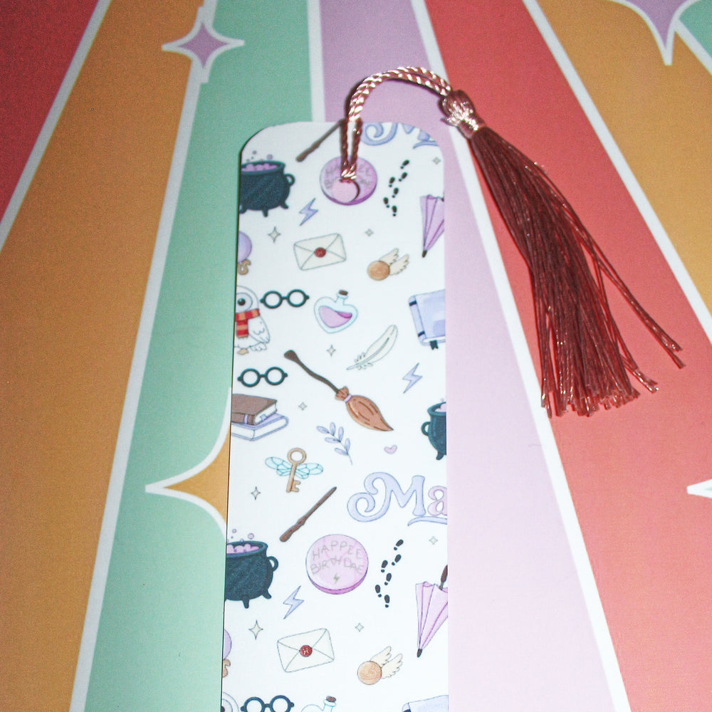 Decorative bookmark with tassel on a colorful striped background