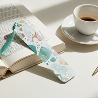 Load image into Gallery viewer, Open book with a decorative bookmark, cup of coffee, and pen on a light surface

