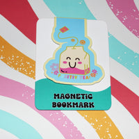 Load image into Gallery viewer, Magnetic bookmark with a cartoon tea bag design on a colorful striped background
