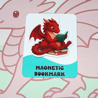 Load image into Gallery viewer, Red dragon magnetic bookmark on a pink and green background
