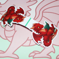 Load image into Gallery viewer, opened red dragon magnetic bookmark on a pink and green background
