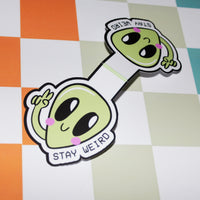 Load image into Gallery viewer, opened bookmark cartoon alien-shaped with 'Stay Weird' text on a checkered background.
