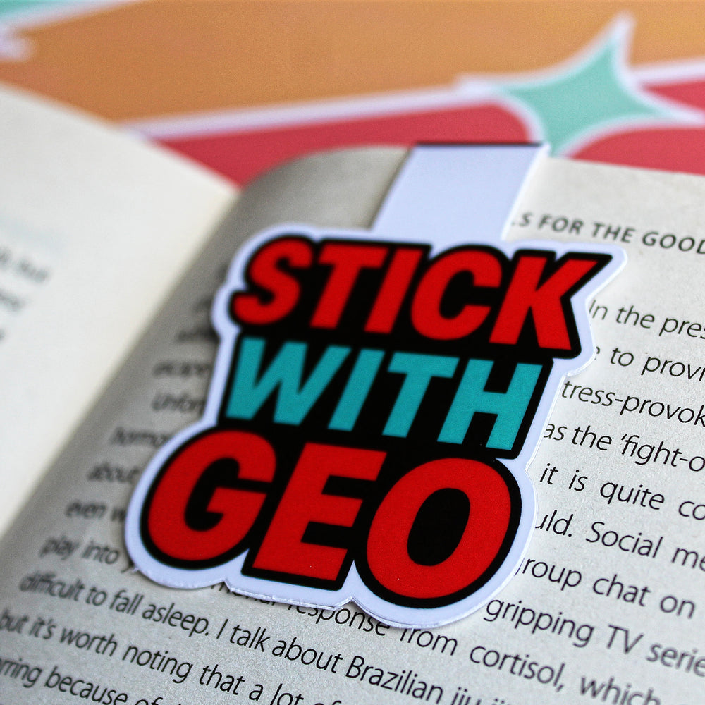 Magnetic bookmark with 'Stick with Geo' text on an open book