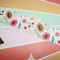Load image into Gallery viewer, Floral bookmark with a tassel on a colorful striped background
