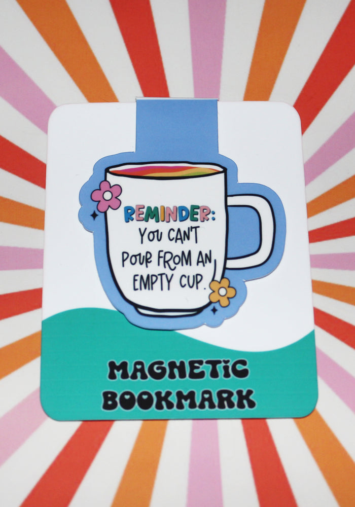 Magnetic bookmark with a mug illustration and text on a colorful radial background