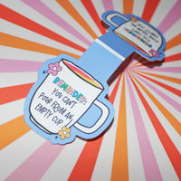 Load image into Gallery viewer, Colourful magnetic bookmark - shaped like a coffee cup with text on a multicoloured radial background
