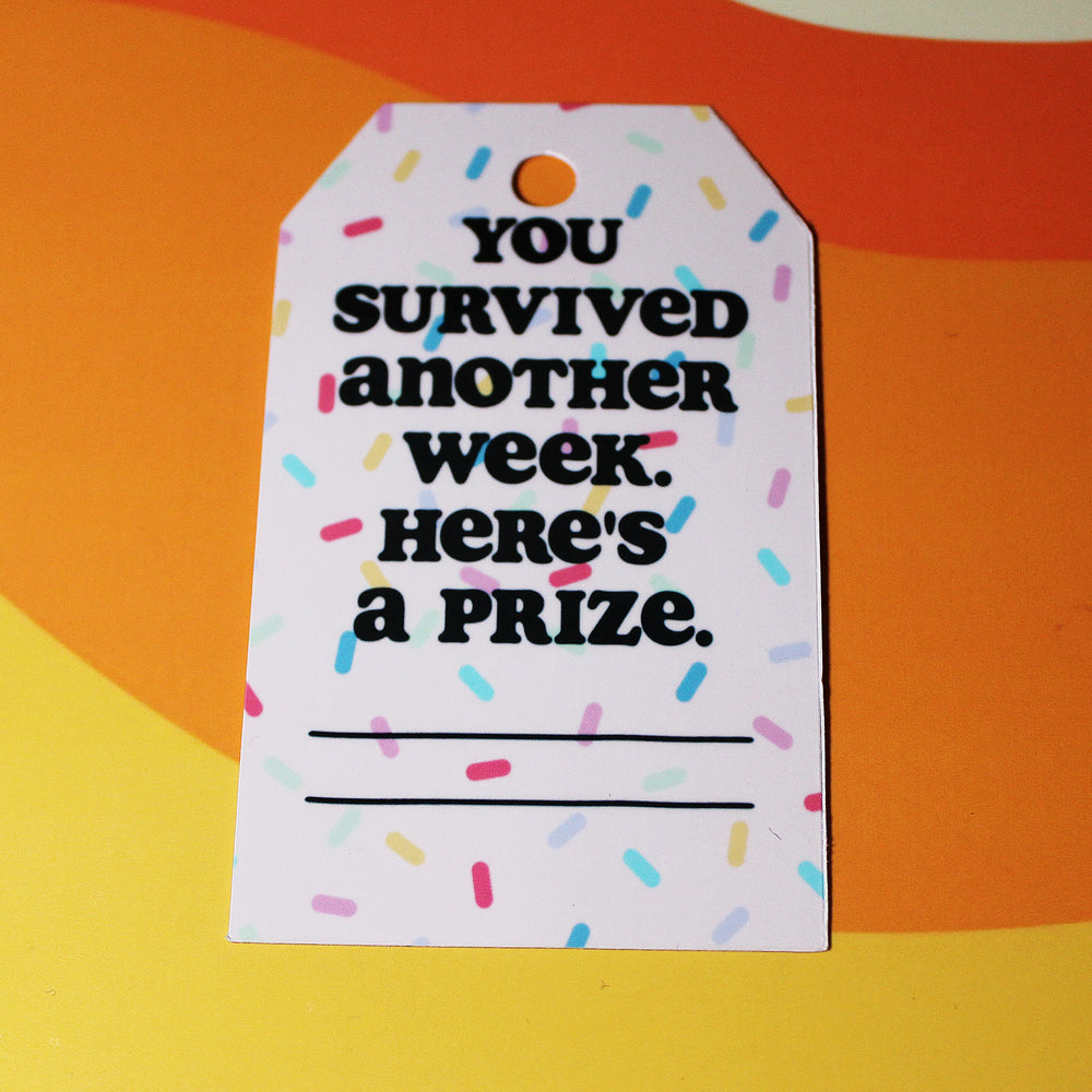 Motivational tag with text 'You survived another week. Here's a prize.' on a colorful background