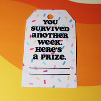 Load image into Gallery viewer, Motivational tag with text 'You survived another week. Here's a prize.' on a colorful background
