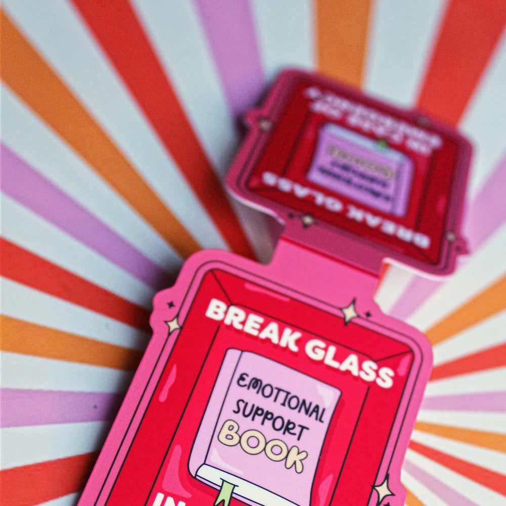 Red emergency support book with 'Break Glass' text on a colorful striped background