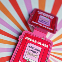 Load image into Gallery viewer, Red emergency support book with 'Break Glass' text on a colorful striped background
