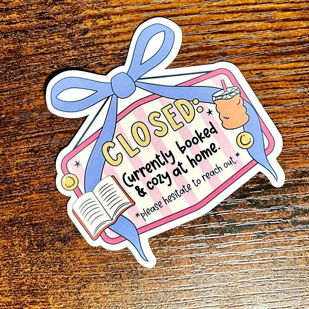 Sticker with a cartoon character and text on a wooden surface