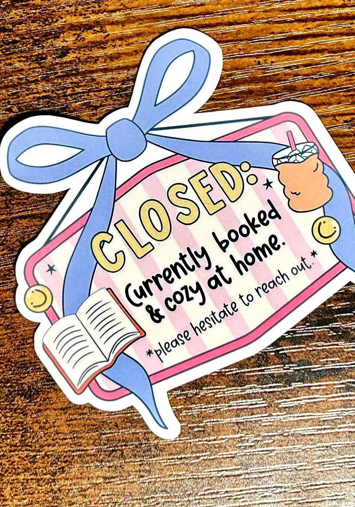 Sticker with a cartoon character and text on a wooden surface