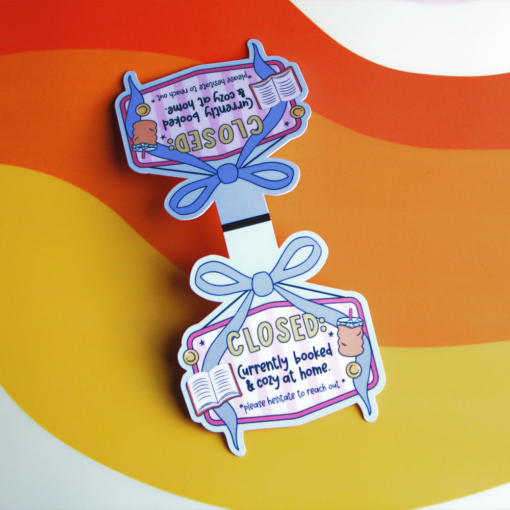 magnetic bookmark with 'CLOSED' sign and blue ribbon on a colourful background
