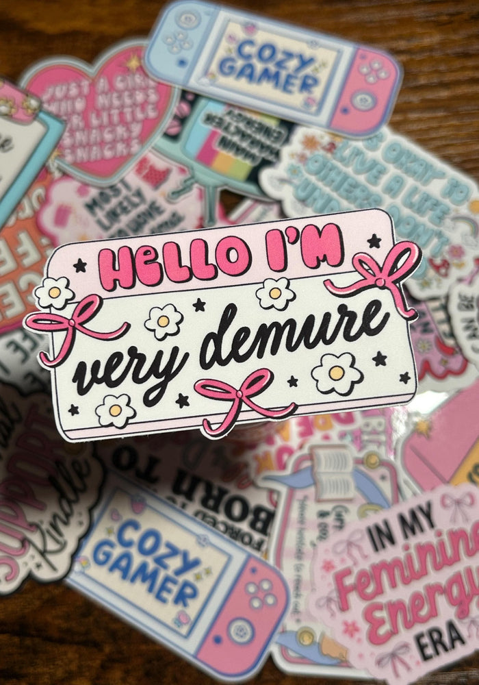 Collection of colorful stickers with various designs and text on a wooden surface.